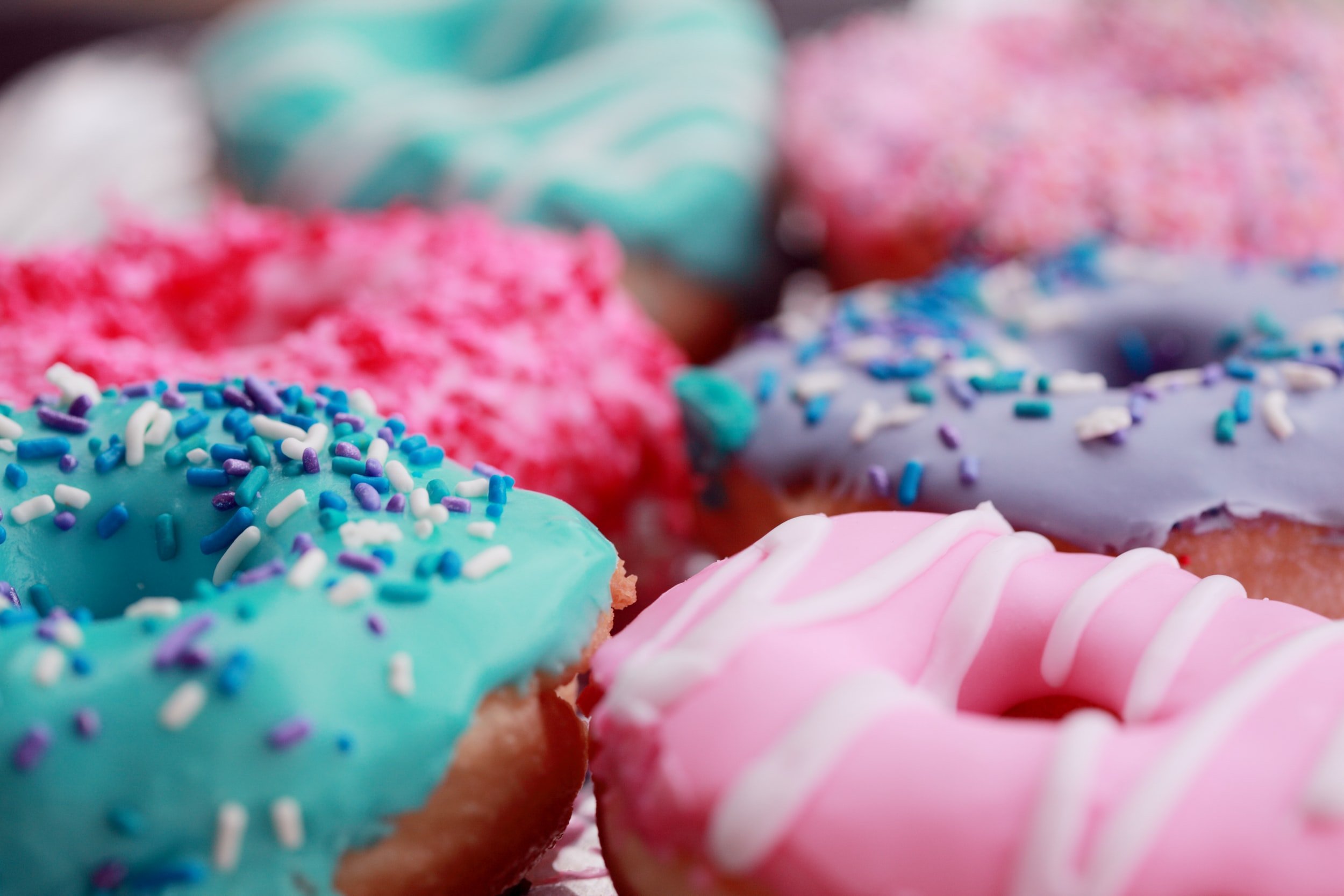 Photo of donuts decorated in blue and pink colors